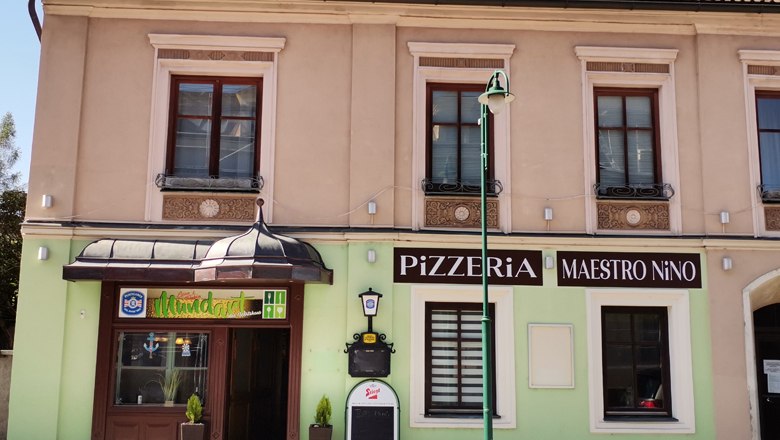 Pizzeria im Ortszentrum, © Wiener Alpen Fassade einer Pizzeria mit dem Namen Maestro Nino in einem zweistöckigen Gebäude.