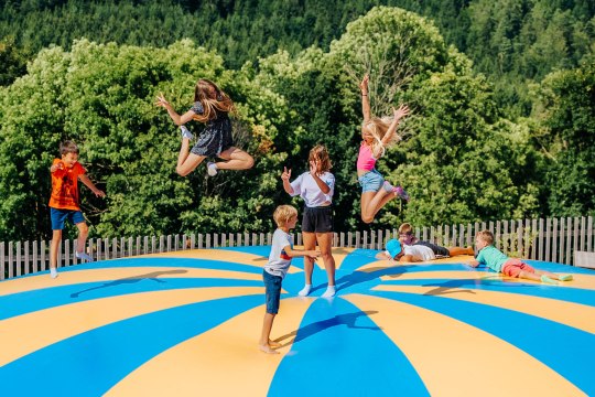 Spaß im Eis-Greissler Erlebnispark, © Blochberger Eisproduktion GmbH Fünf Kinder springen auf einem Trampolin