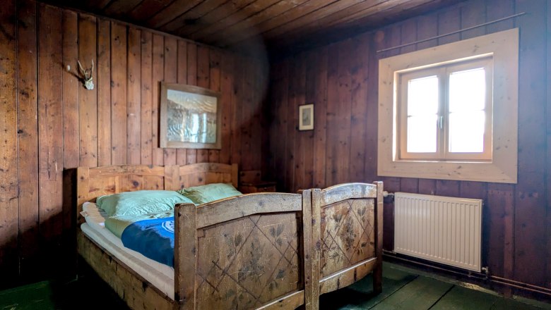 Karl-Ludwig-Haus Doppelzimmer, © Kai Weidinger Rustikales Doppelzimmer mit Holzwänden und -möbeln, zwei Einzelbetten, Fenster und Heizung.