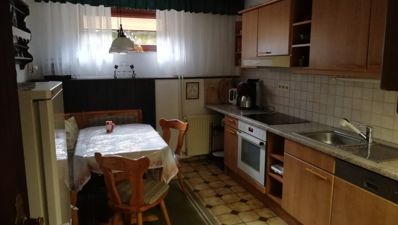 Kitchen, © Kesper Cozy kitchen with wooden furniture, dining table, chairs and kitchen utensils.