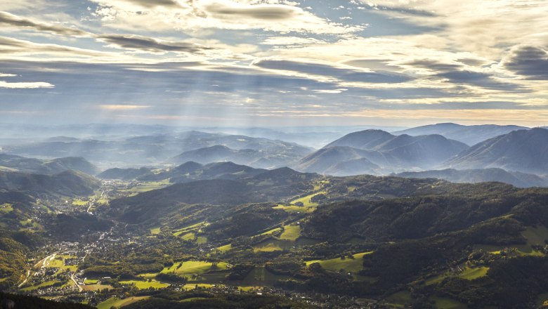 Rax view, © Wiener Alpen - Croy Panoramic view of the Rax Alps with wooded hills and rays of sunshine through clouds.