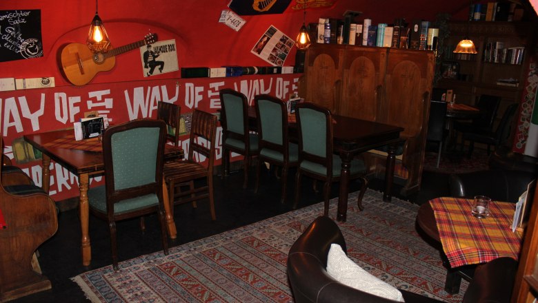 Seating alcove in the rear area, © Mary´s Scottish Coffeepub Cozy seating area in a café with wooden furniture and decorations on the walls.