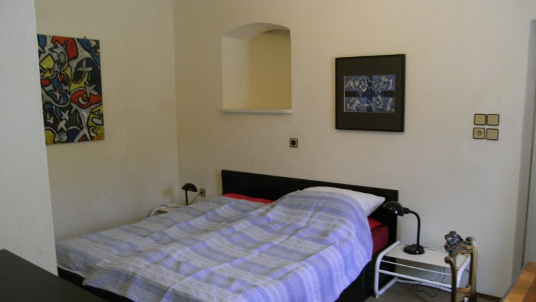 One bedroom with a double bed, two bedside tables and two murals.