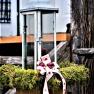 Lantern decorated with moss and ribbon.