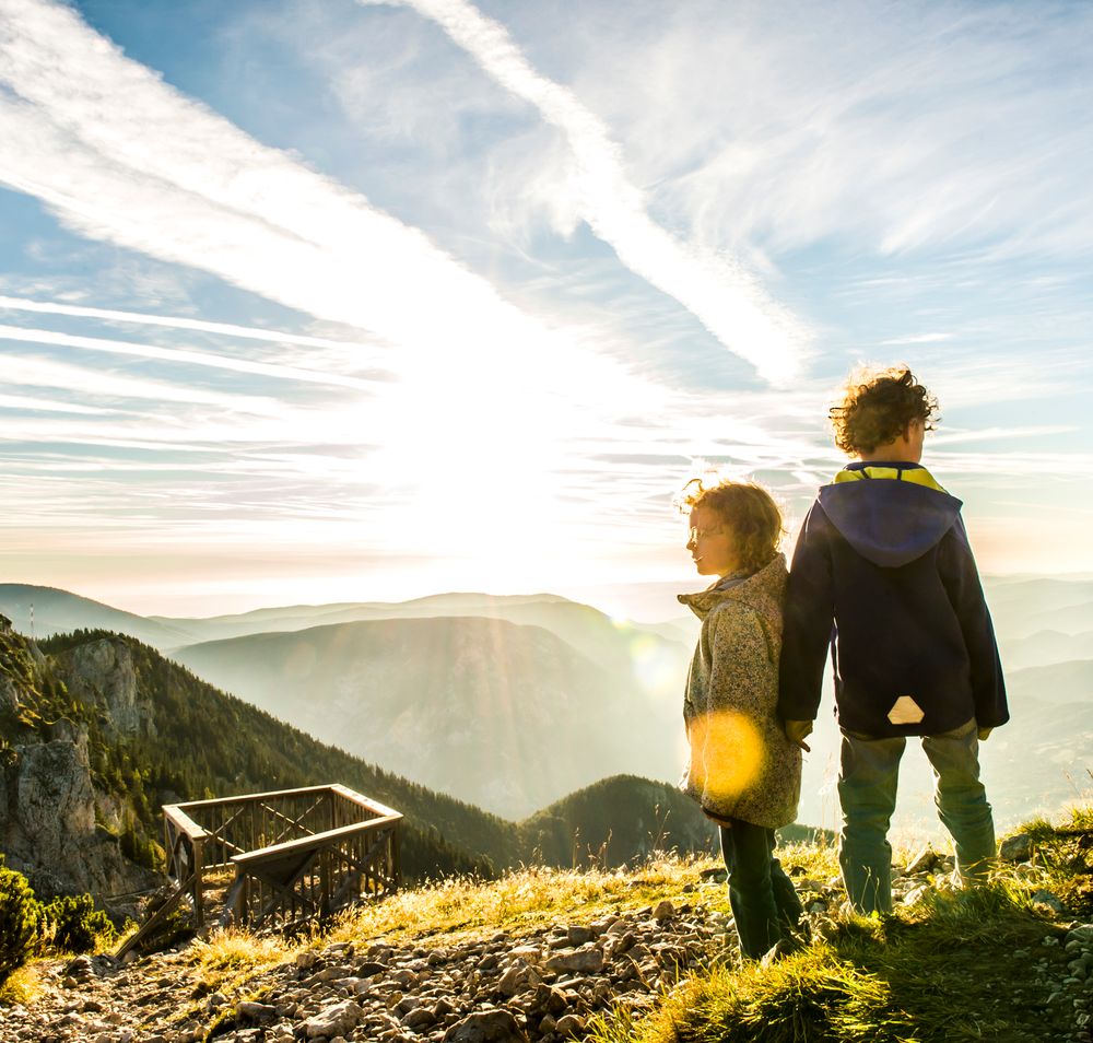 Cable car in the mountains with views of wooded slopes and valleys.