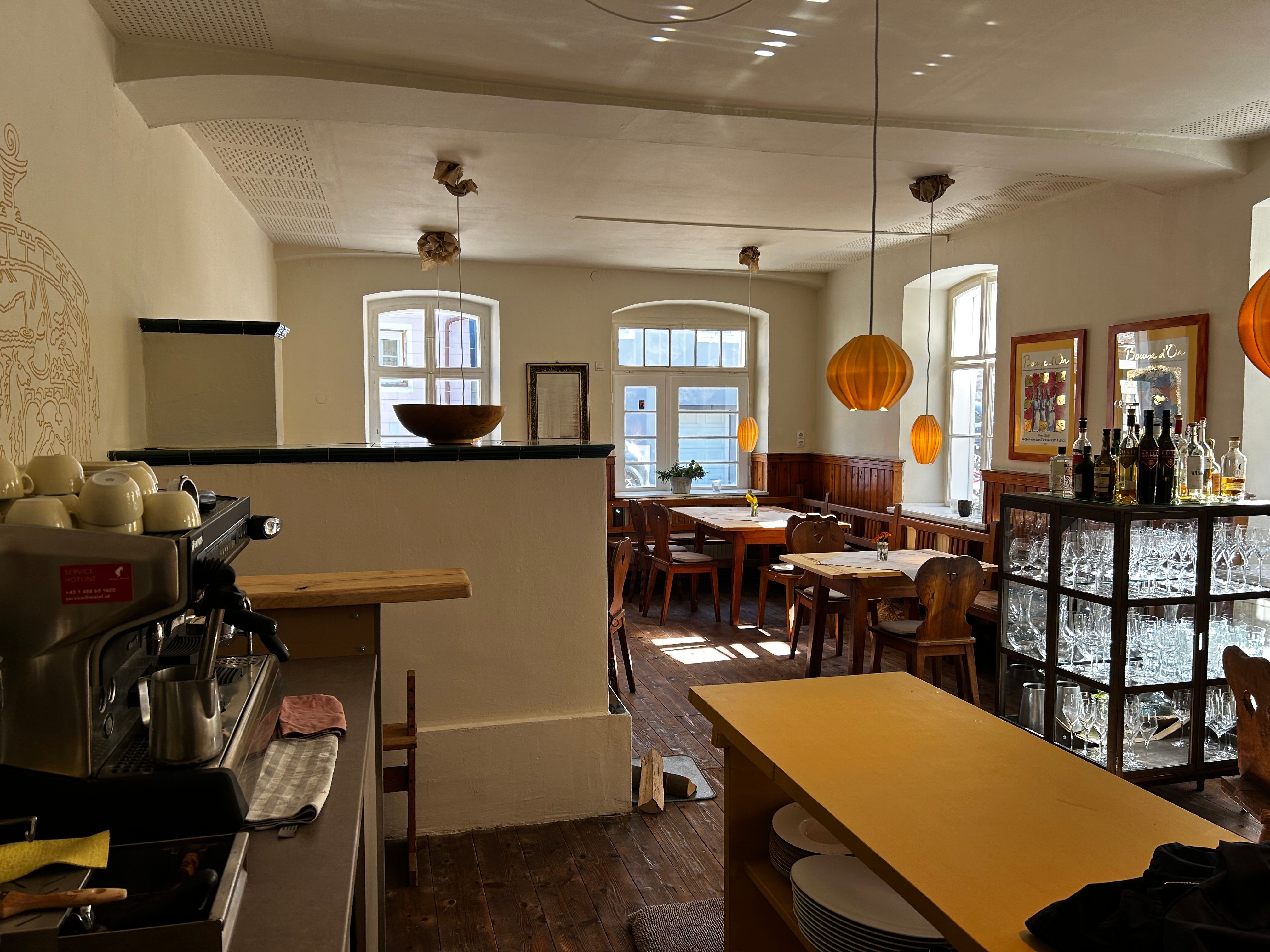 Interior view of a cozy inn with wooden furniture and warm light.