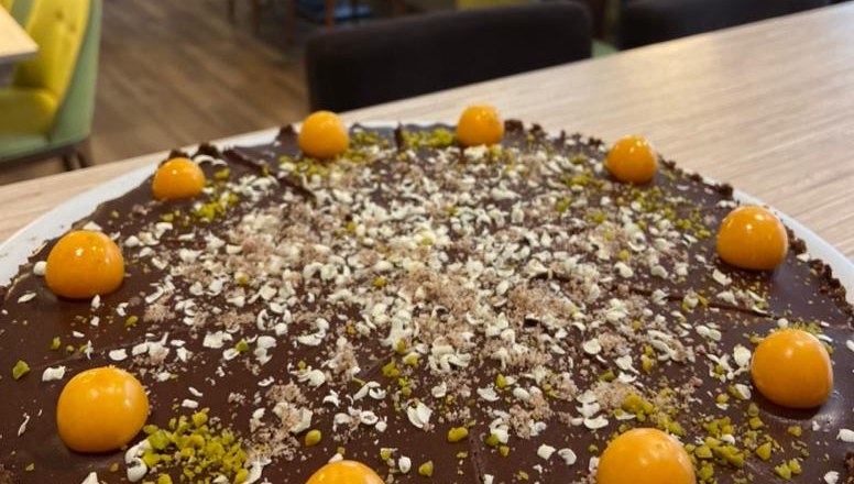 Chocolate cake with physalis in a café.