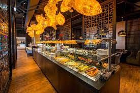 A buffet in a stylish restaurant with warm lighting and decorative elements.