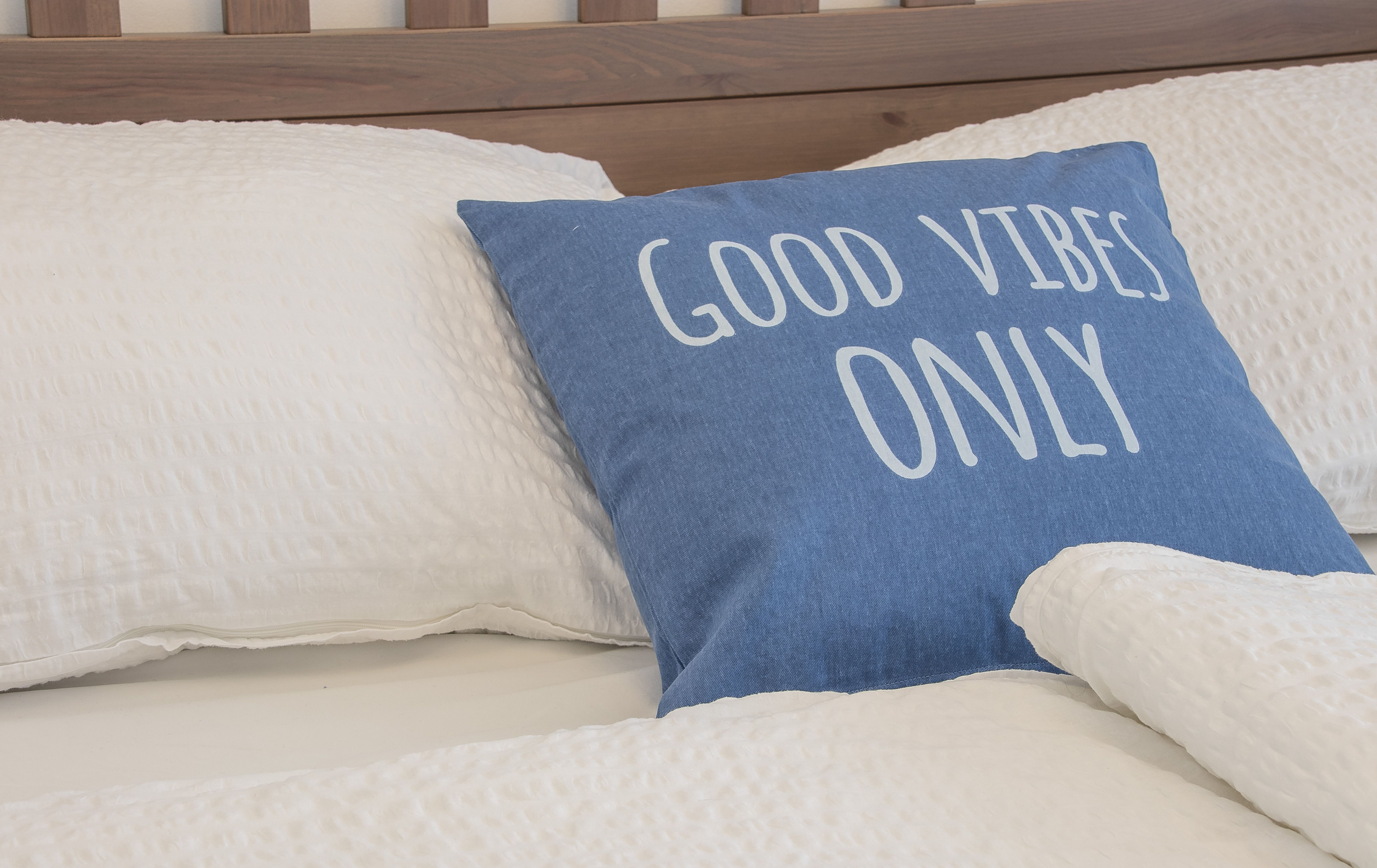 Bed with "Good Vibes Only" upholstery