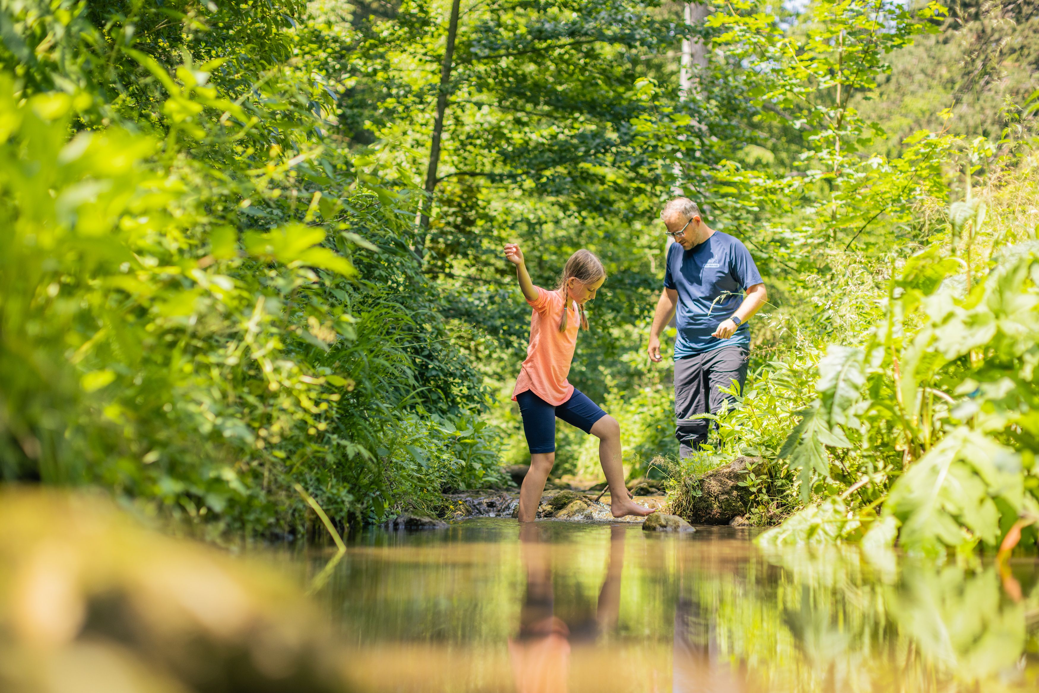 Familie erfrischt sich im Wasser der Klamm
