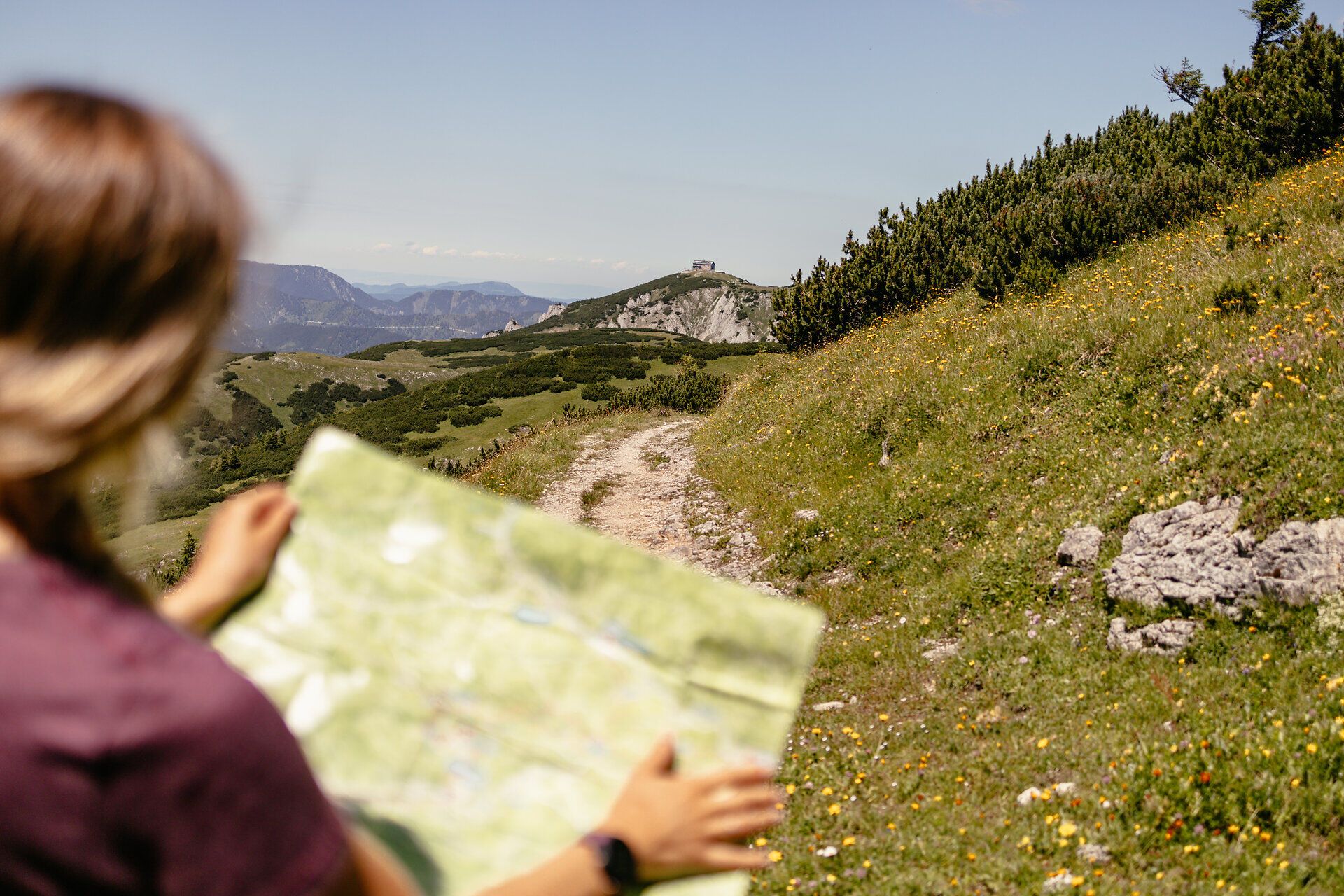 Ein sanfter Wanderweg schlängelt sich durch die blühenden Wiesen, während die warmen Sonnenstrahlen die Landschaft erhellen. Die frische Bergluft und das Rascheln der Blätter laden dazu ein, die Natur in vollen Zügen zu genießen. Mit einer Karte in der Hand und dem Ziel vor Augen, wird jeder Schritt zu einem unvergesslichen Abenteuer.