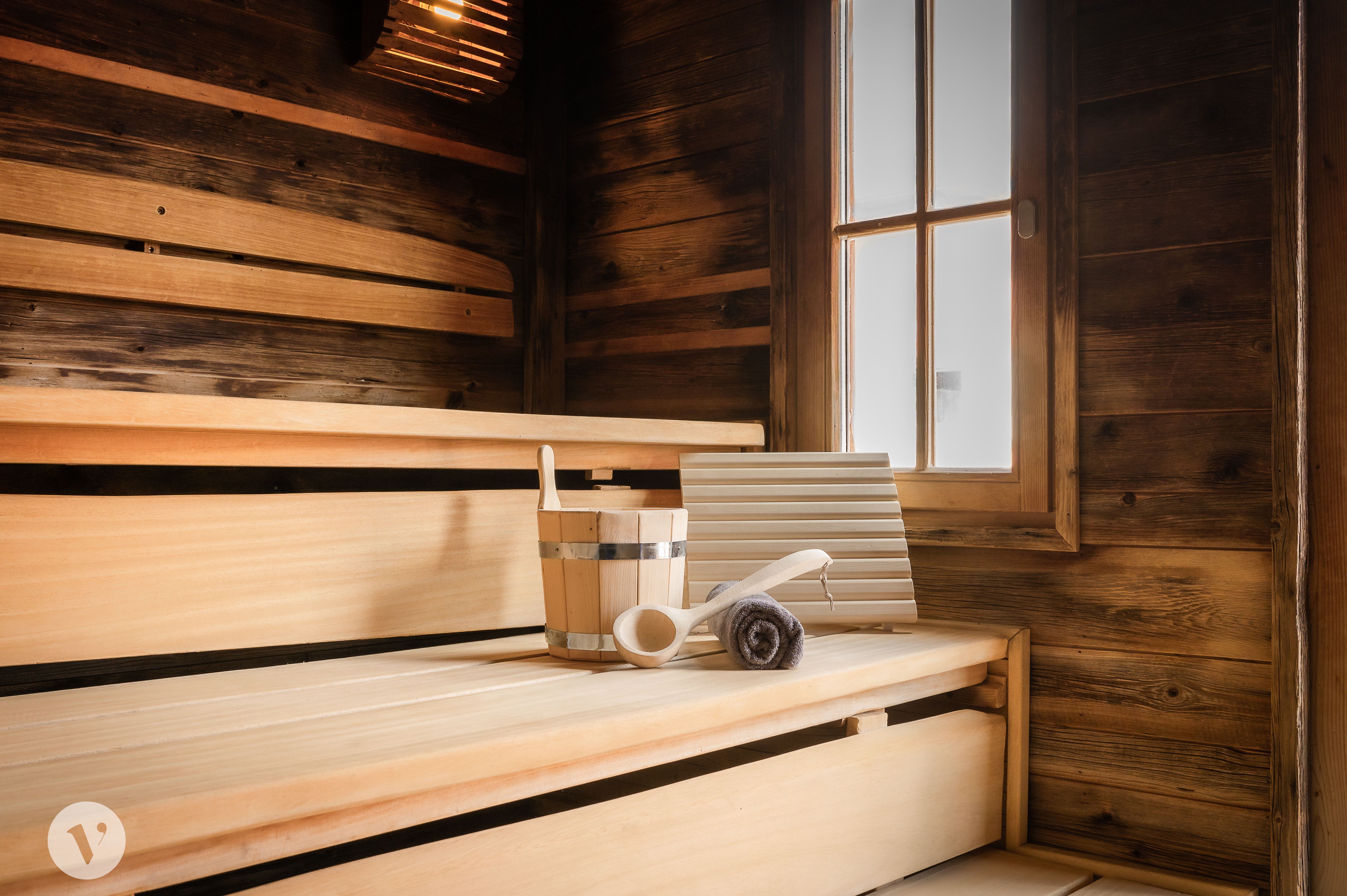 Holzsauna mit Wasserkübel und Handtuch