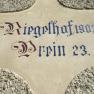 Inschrift 'Riegelhof 1903 Prein 23' auf einer Wand.