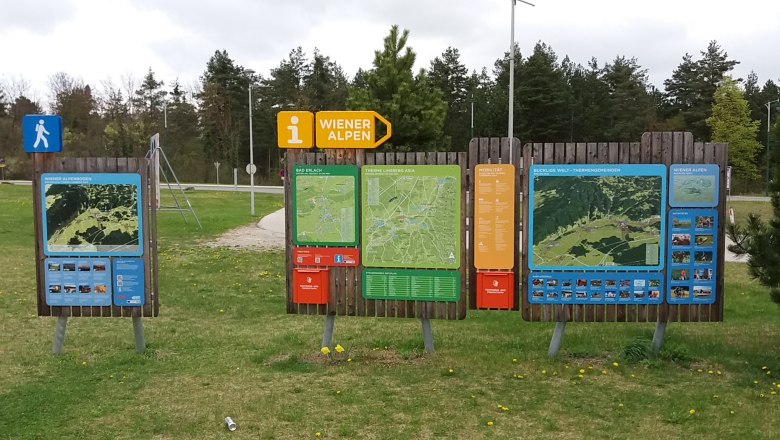 Hiking starting point with large, colorful information boards in the Vienna Alps.