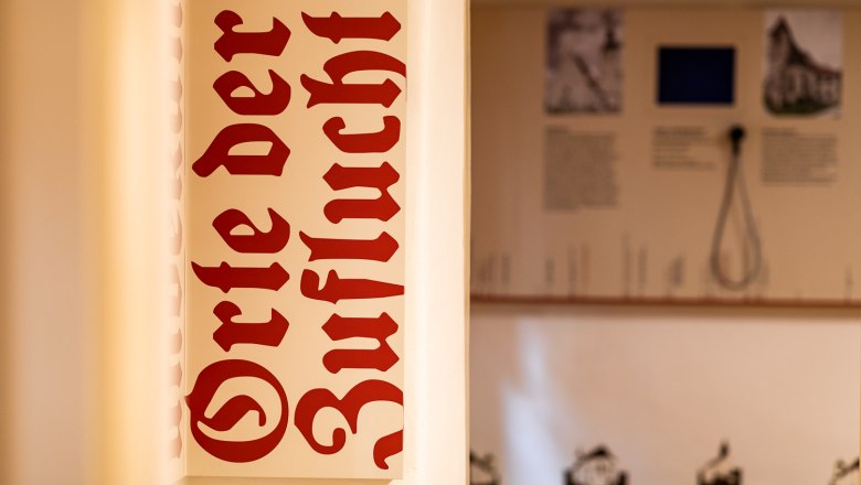 A sign with the inscription 'Places of Refuge' in the exhibition.