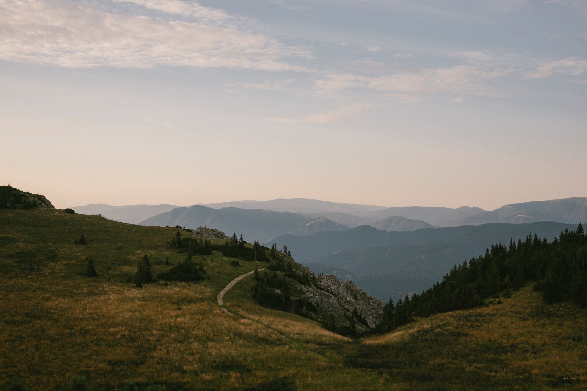 Evening atmosphere over the Rax mountain range with a hiking trail