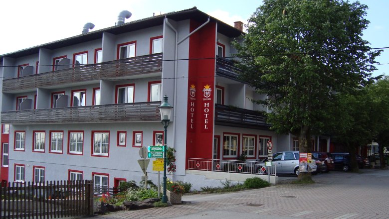 Exterior view of the Hotel Thier with balconies and red lettering.
