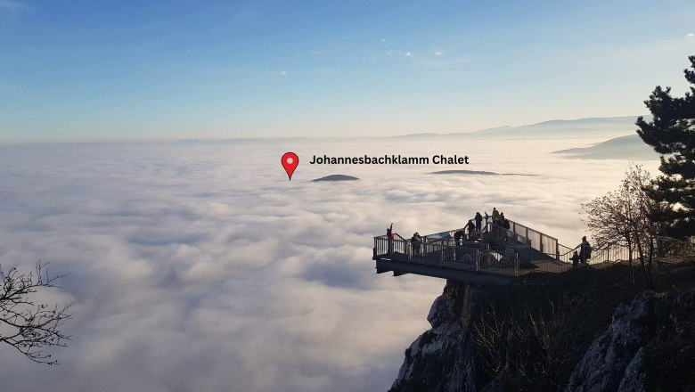 Skywalk Hohe Wand above a cloud cover with a view of the Johannesbachklamm Chalet.