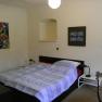One bedroom with a double bed, two bedside tables and two murals.