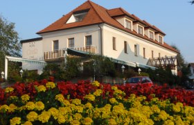 Hotel Geier in Bad Schönau with flower bed in the foreground.