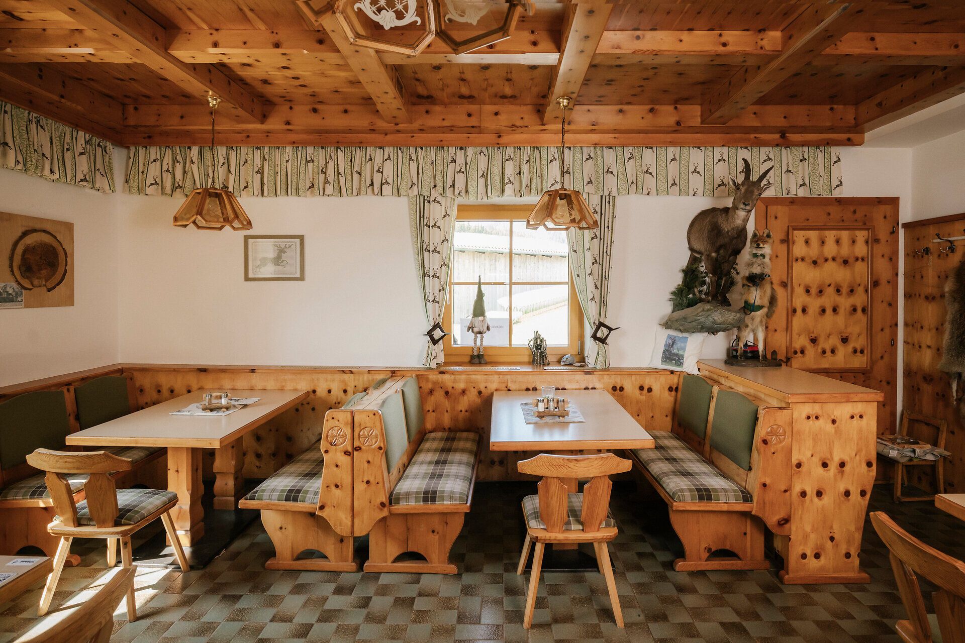 Cozy sitting area with wood paneling at the Almreserlhaus on Schneeberg