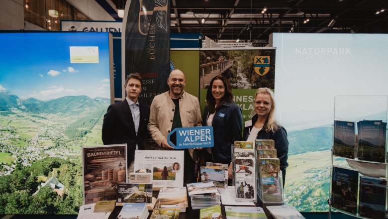 4 Personen vor Prospekten mit dem Wiener alpen Schild 