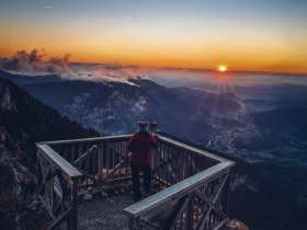 Ein atemberaubender Sonnenaufgang über den majestätischen Bergen, der die Landschaft in warmes Licht taucht. Die frische Bergluft und die Stille der Natur laden dazu ein, den Moment in vollen Zügen zu genießen. Hier, an einem Aussichtspunkt, wird die Schönheit der Wiener Alpen in Niederösterreich spürbar.