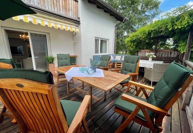 Terrasse, © Peter Klement Holzterrasse mit Tisch, gemütlichen Stühlen und Sonnenschutz.