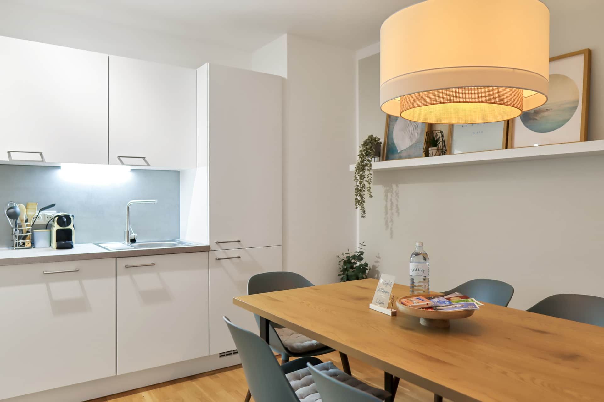 White kitchen with dining room and dining table