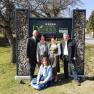Five people in front of a sign with the inscription 'Bauernhof Dissauer Familie Rosinger'.
