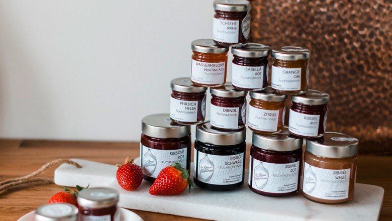 Various jam jars arranged on a table.