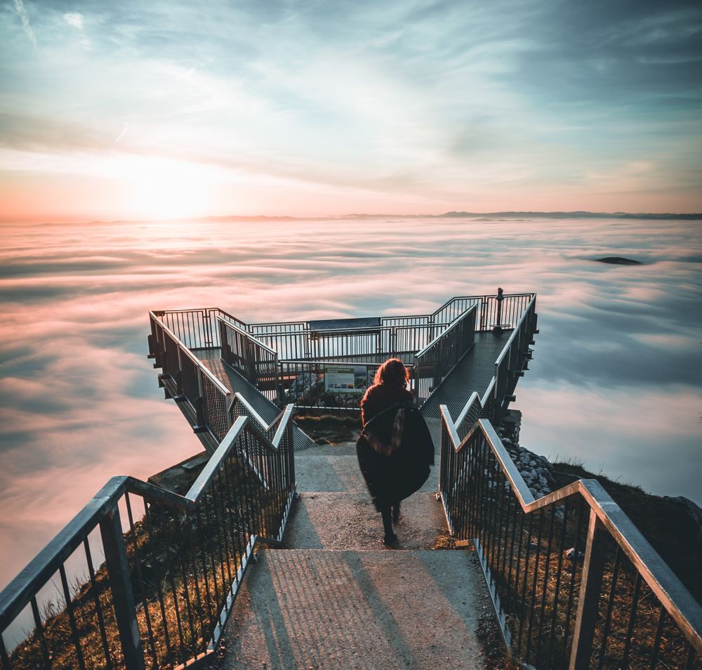A visitor to the Skywalk enjoys the view above the blanket of fog