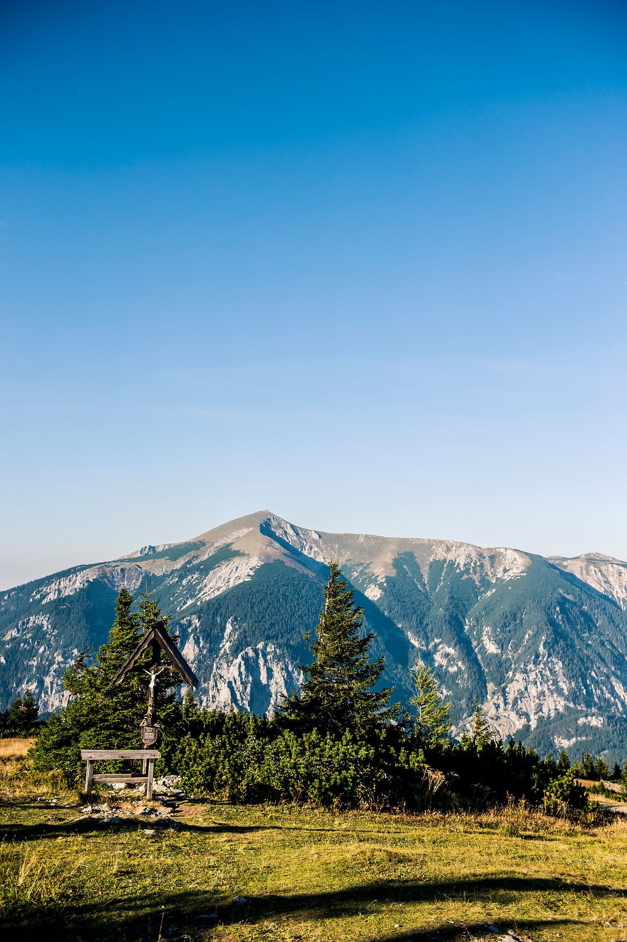 The gentle hills of the Vienna Alps glow in the warm light of a summer's day. A clear sky and the fresh mountain air invite you to enjoy the breathtaking view and experience the tranquillity of nature.