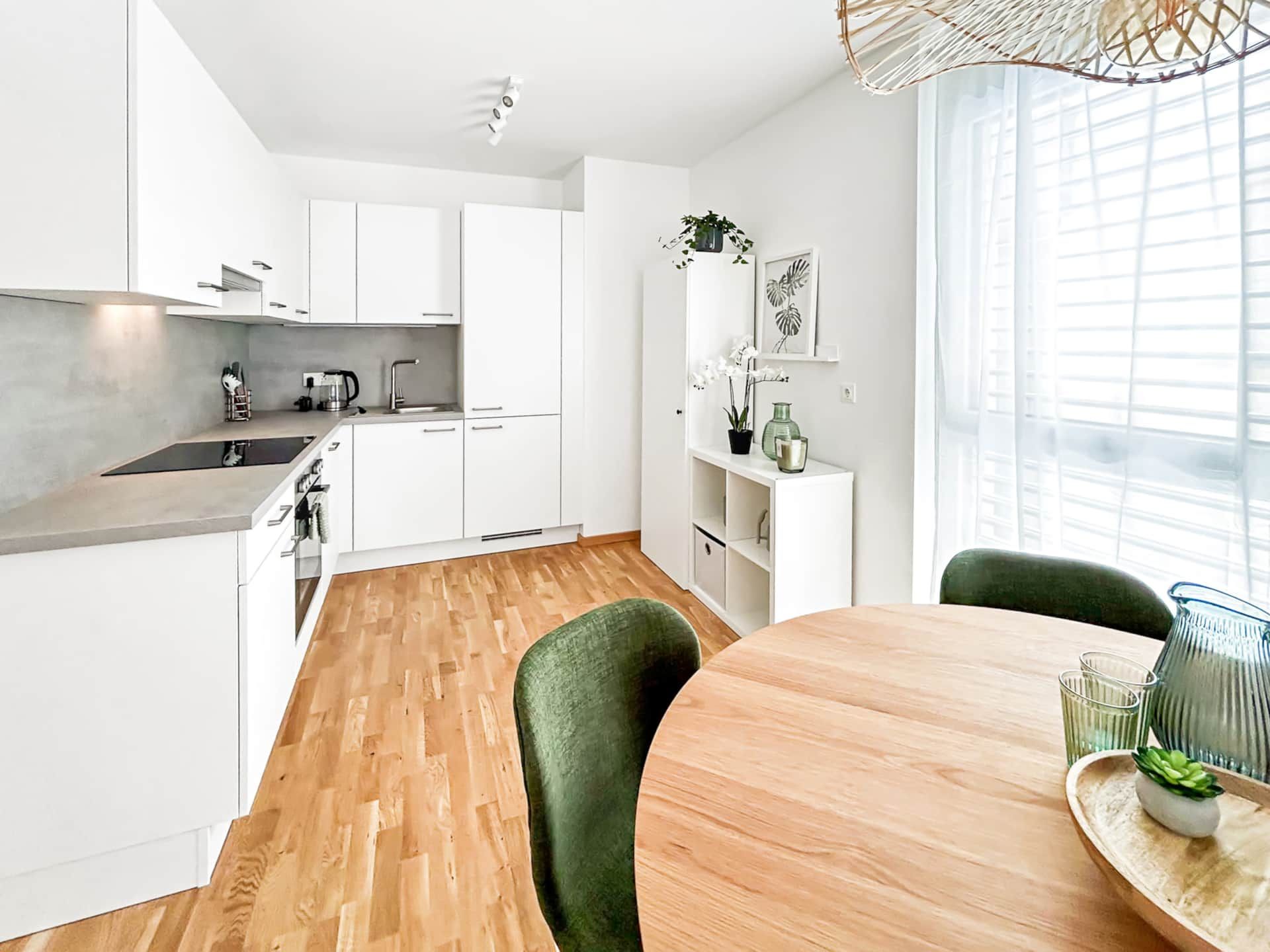 Very bright, large, open kitchen with dining table and access to the balcony. 
