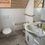 Modern bathroom with skylight, washbasin, toilet and towel rail.