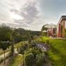 Modern accommodation in a green landscape with sunshades and garden.