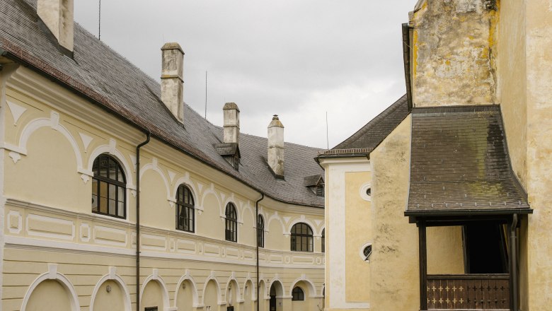 Historic building with yellow façade and arched windows, Gloggnitz.